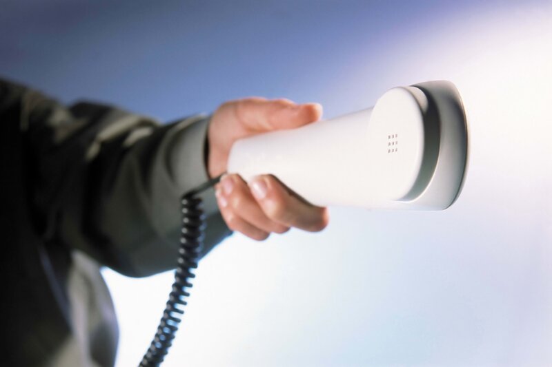 hand holding telephone receiver