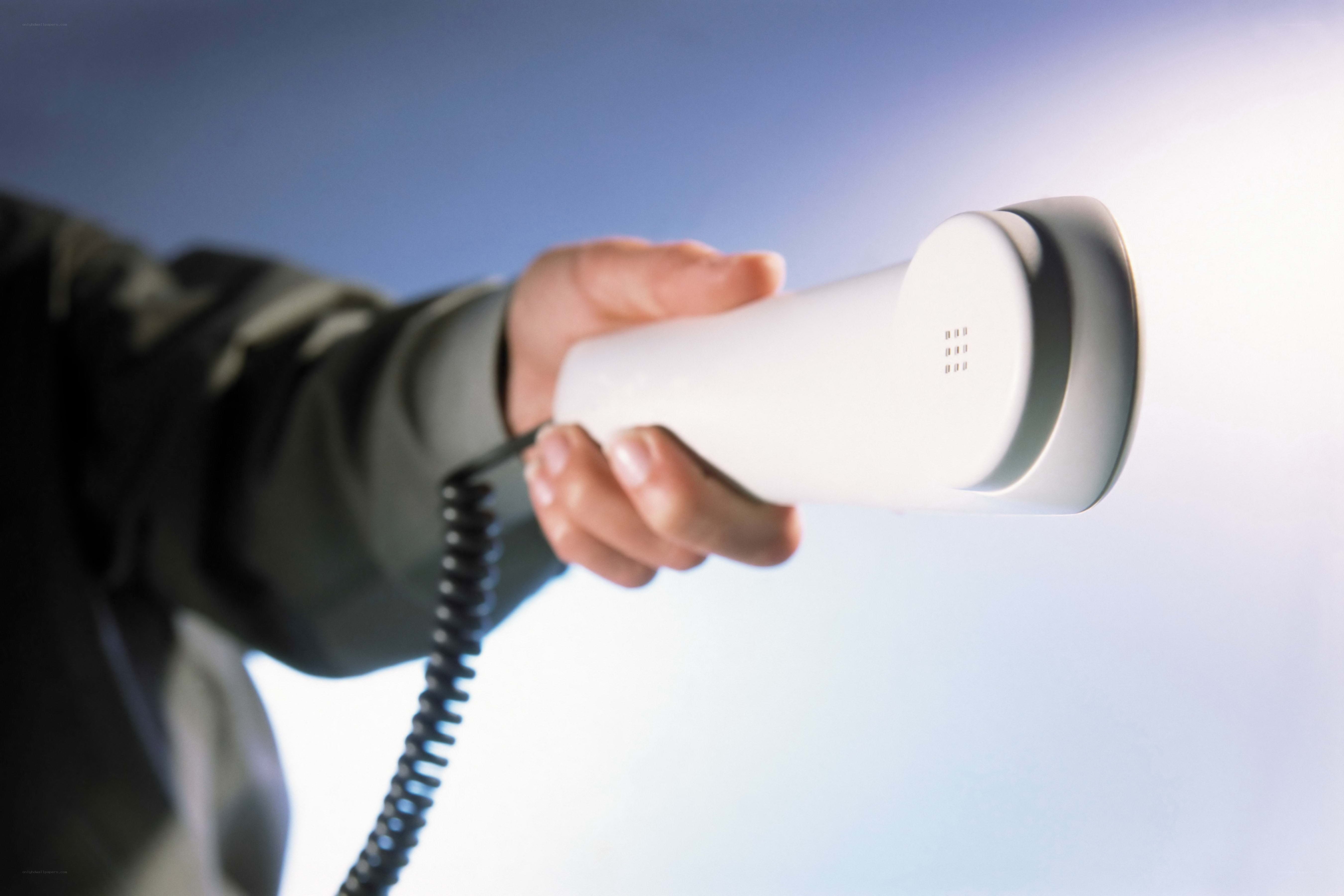hand holding telephone receiver