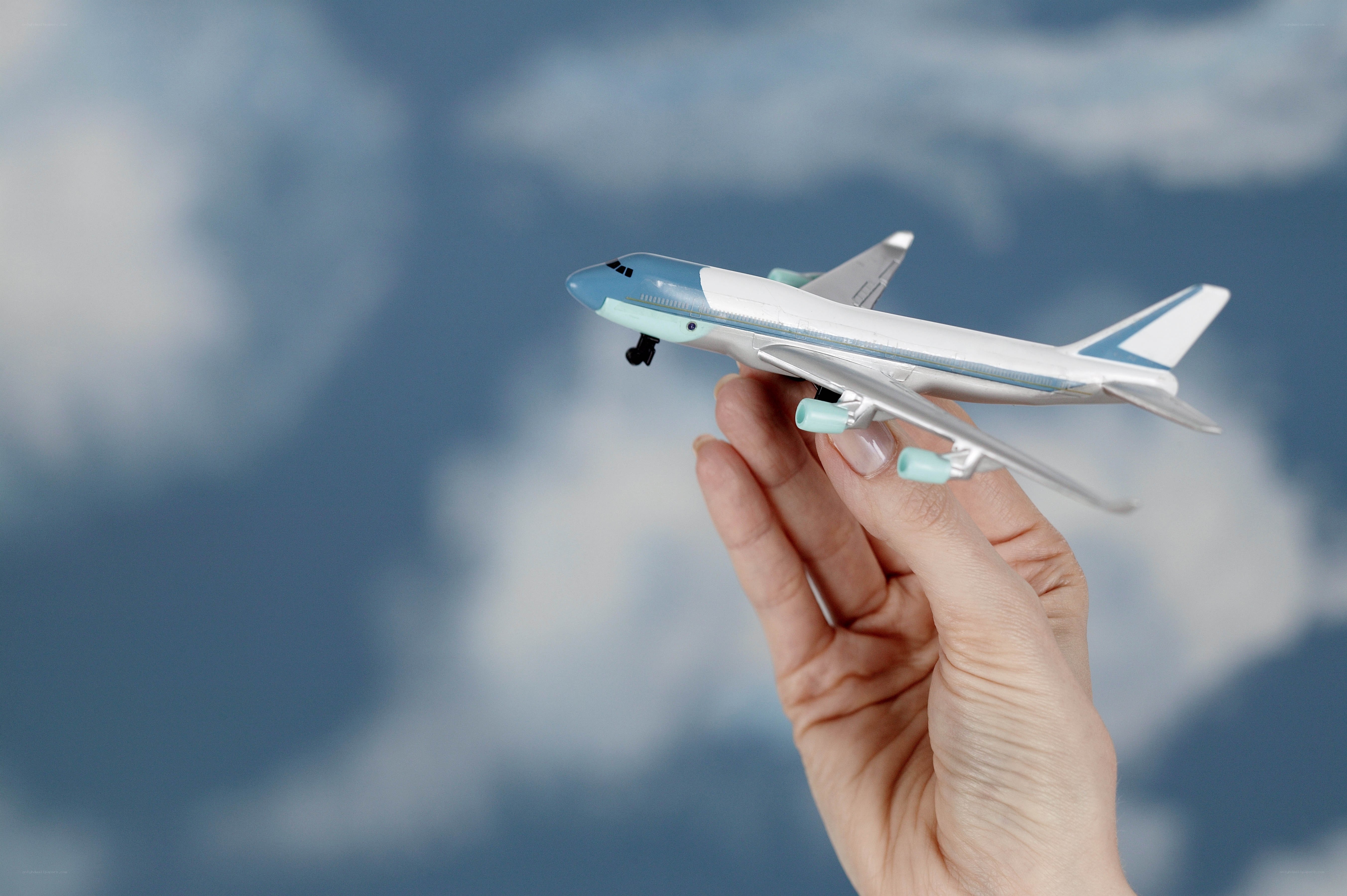 hand holding toy airplane