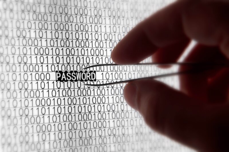 hand holding tweezers over binary code