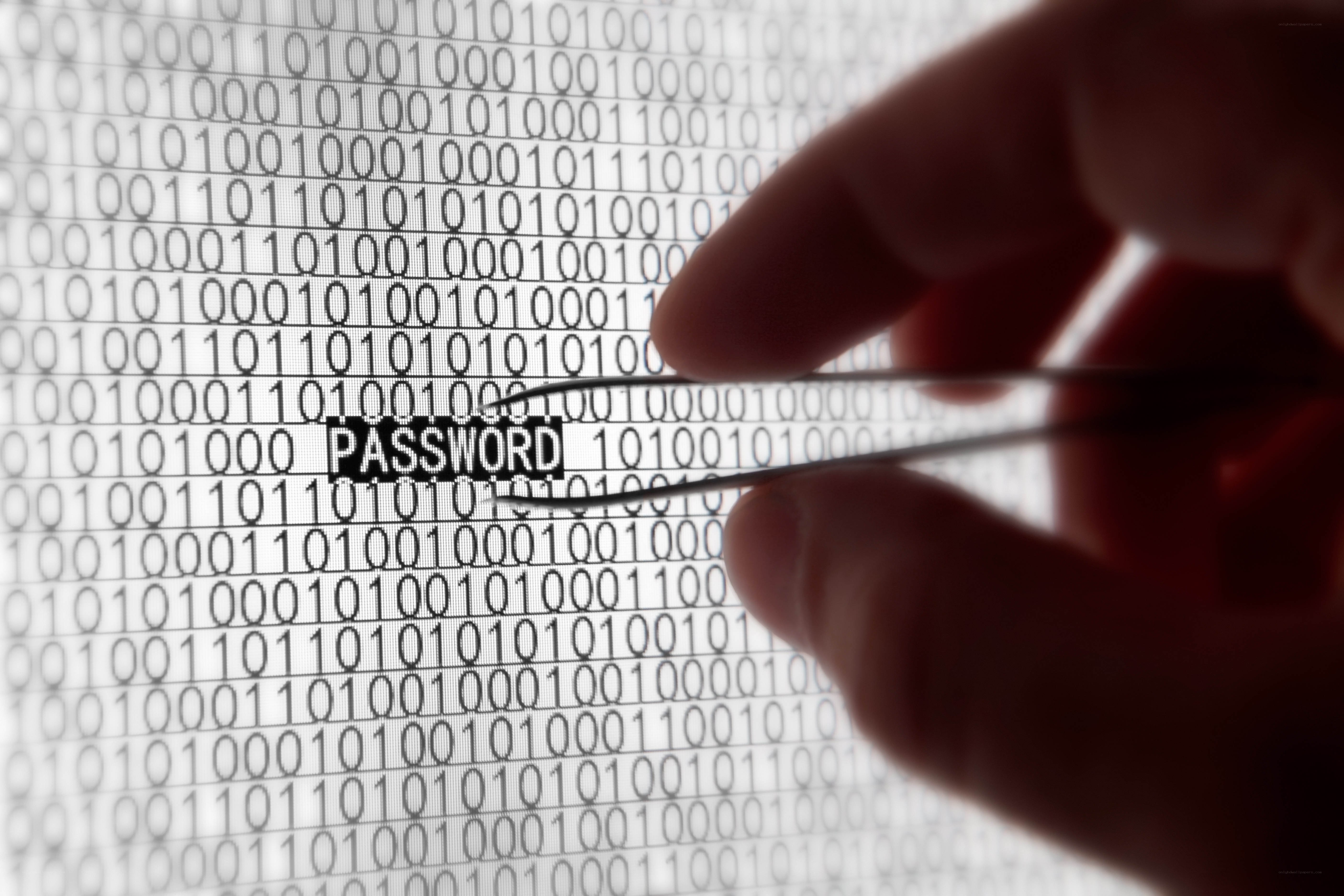 hand holding tweezers over binary code