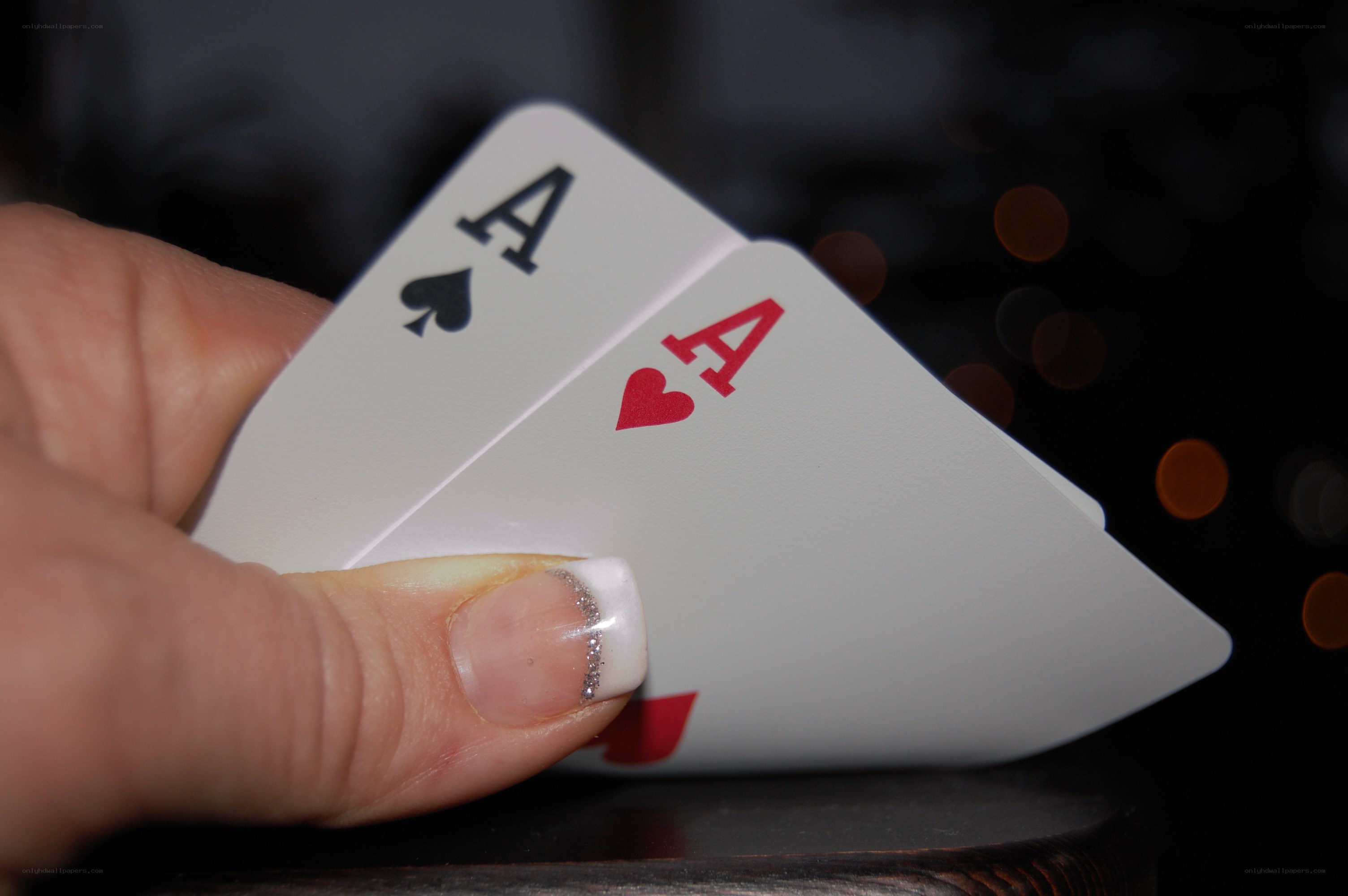 Hand holding two aces