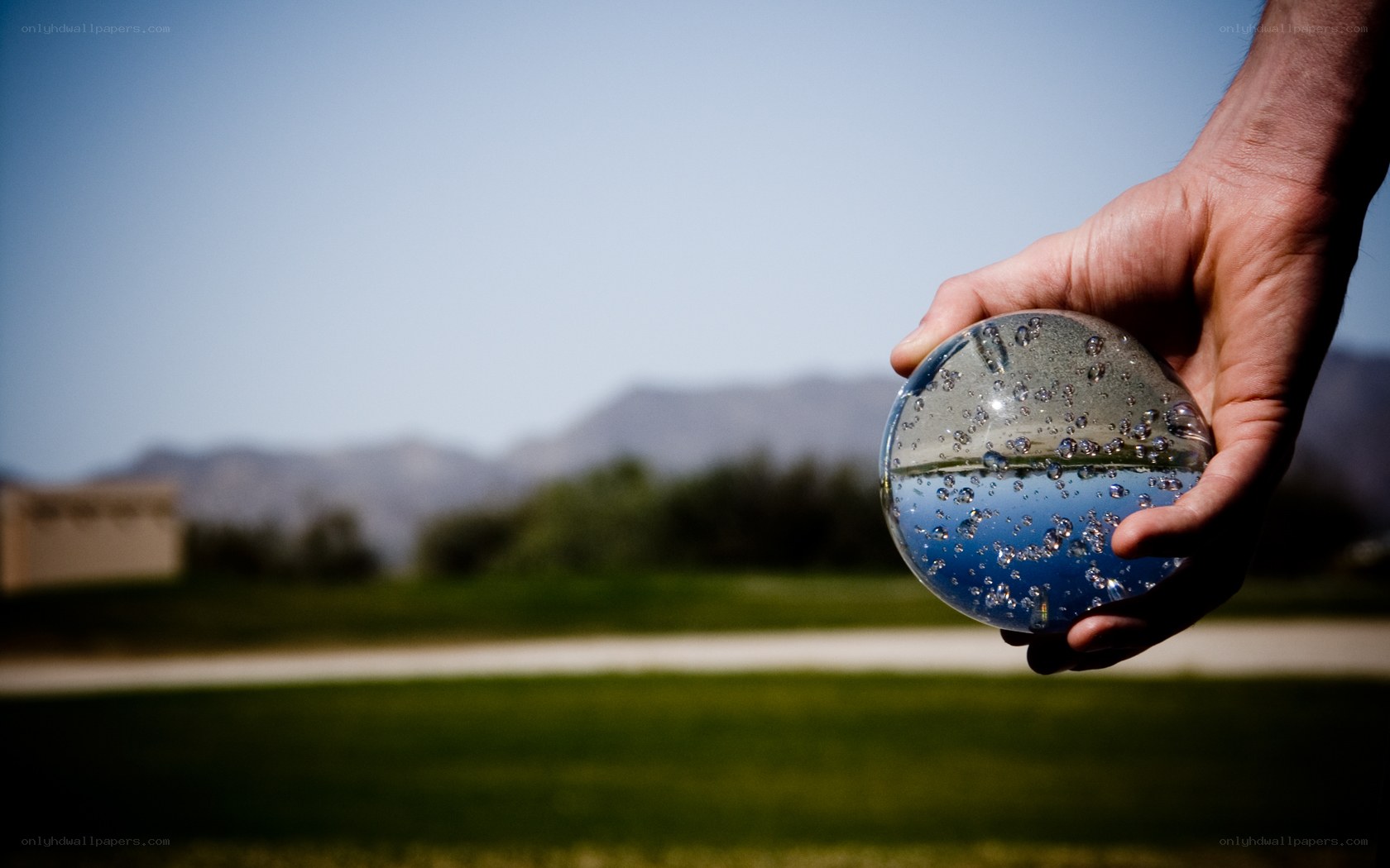 hand holding water sphere