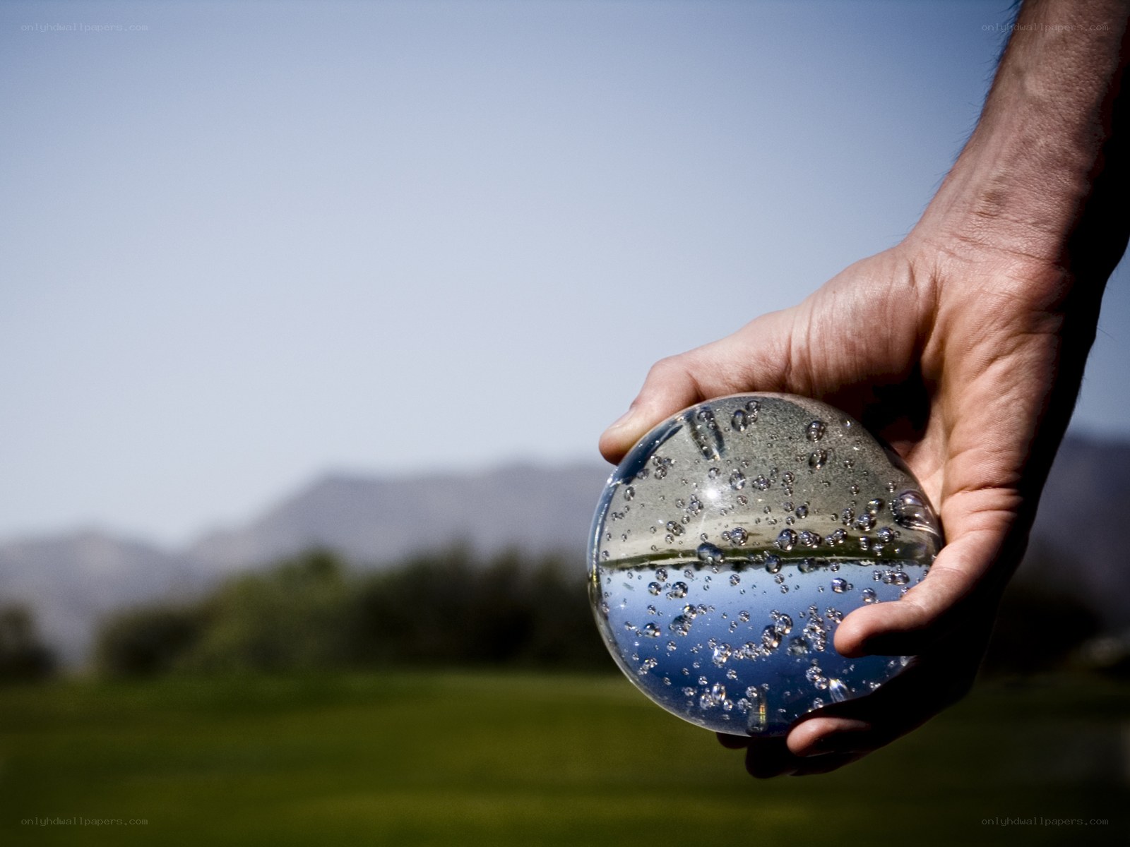 hand holding water sphere