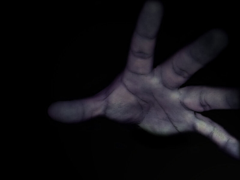 hand in dark with purple tint