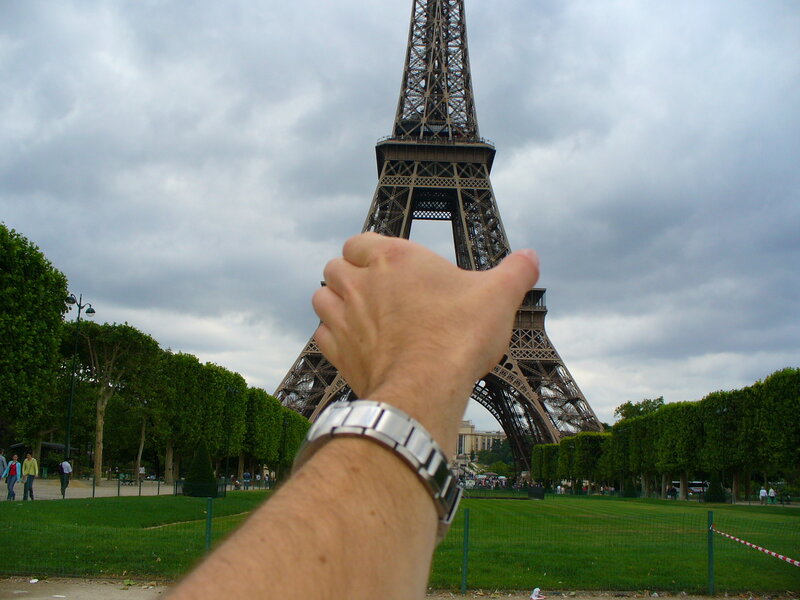 Hand in front of Eiffel Tower