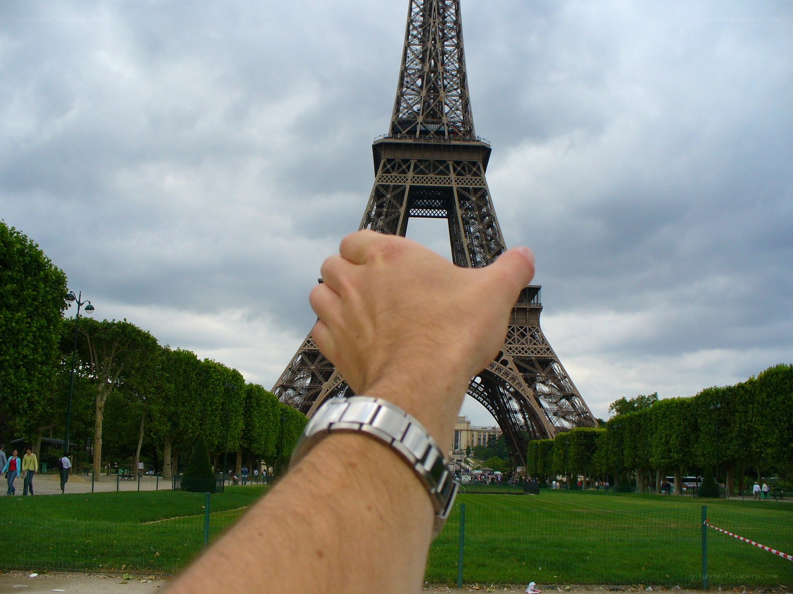 Hand in front of Eiffel Tower