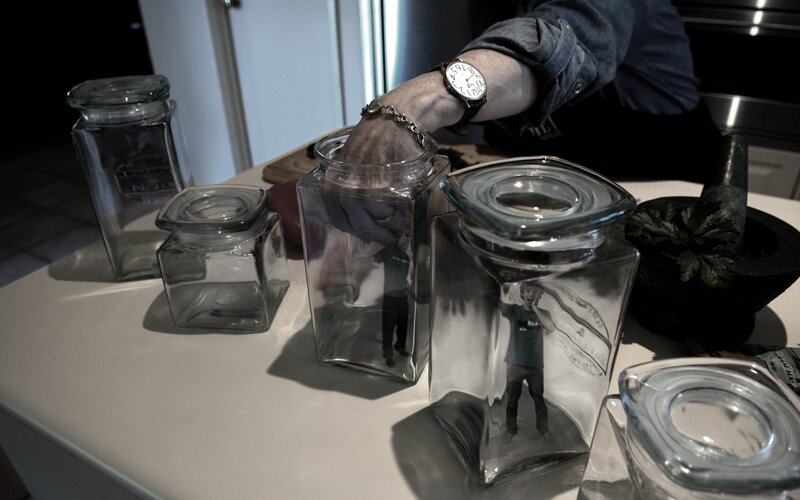 hand in glass jar on counter