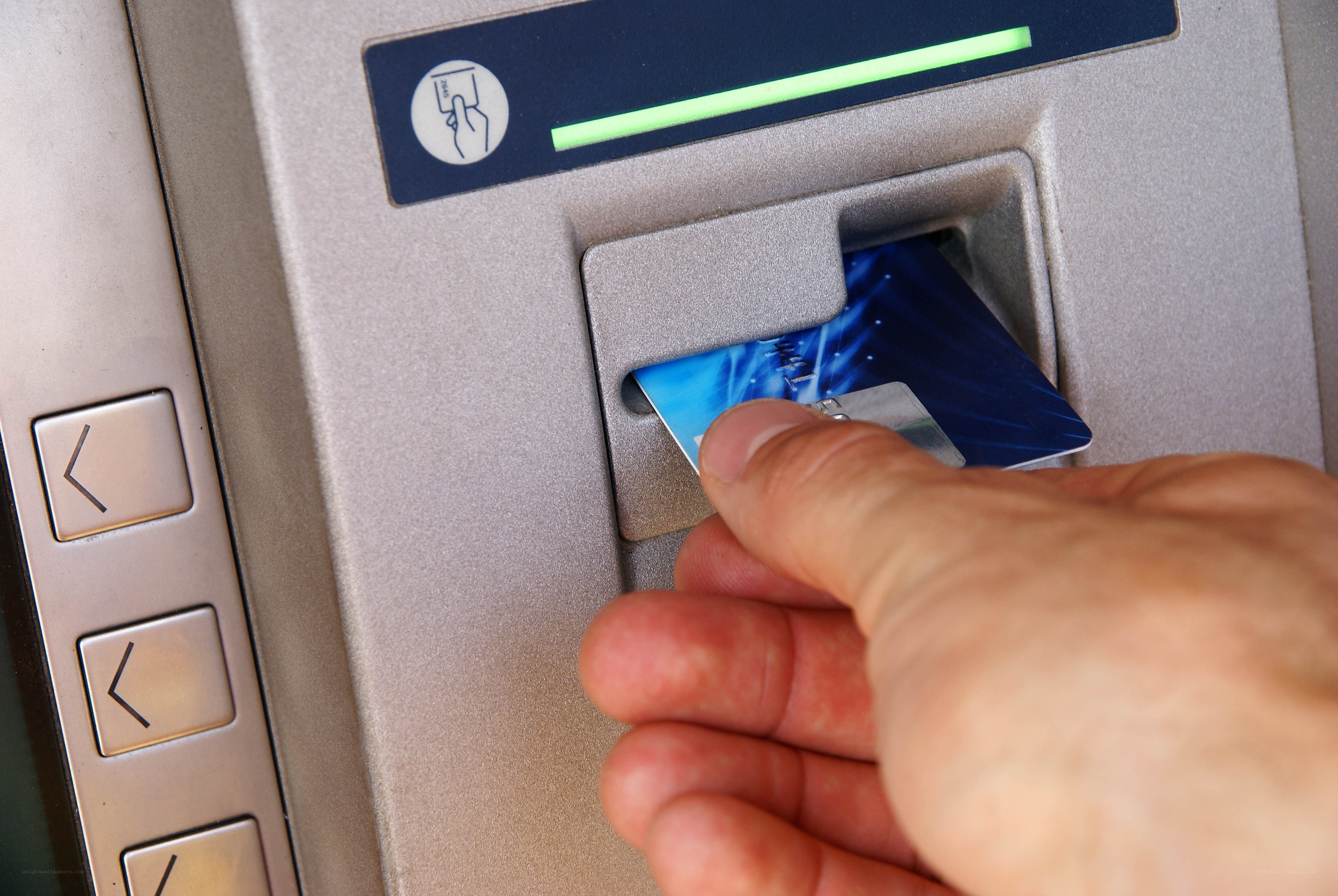 hand inserting card into ATM