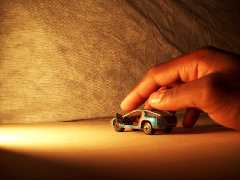 hand moving toy car