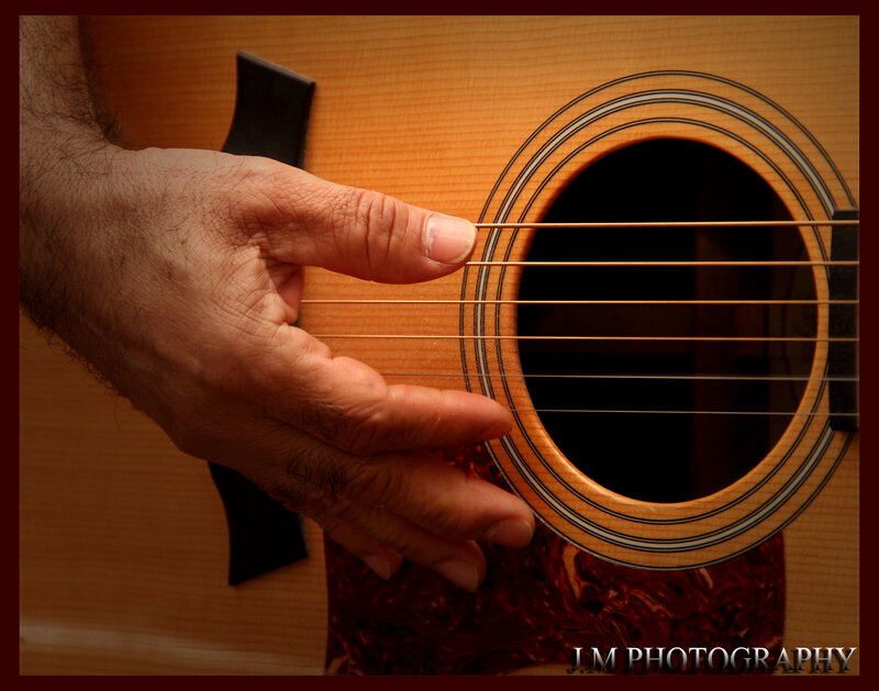 Hand on Acoustic Guitar — Brown