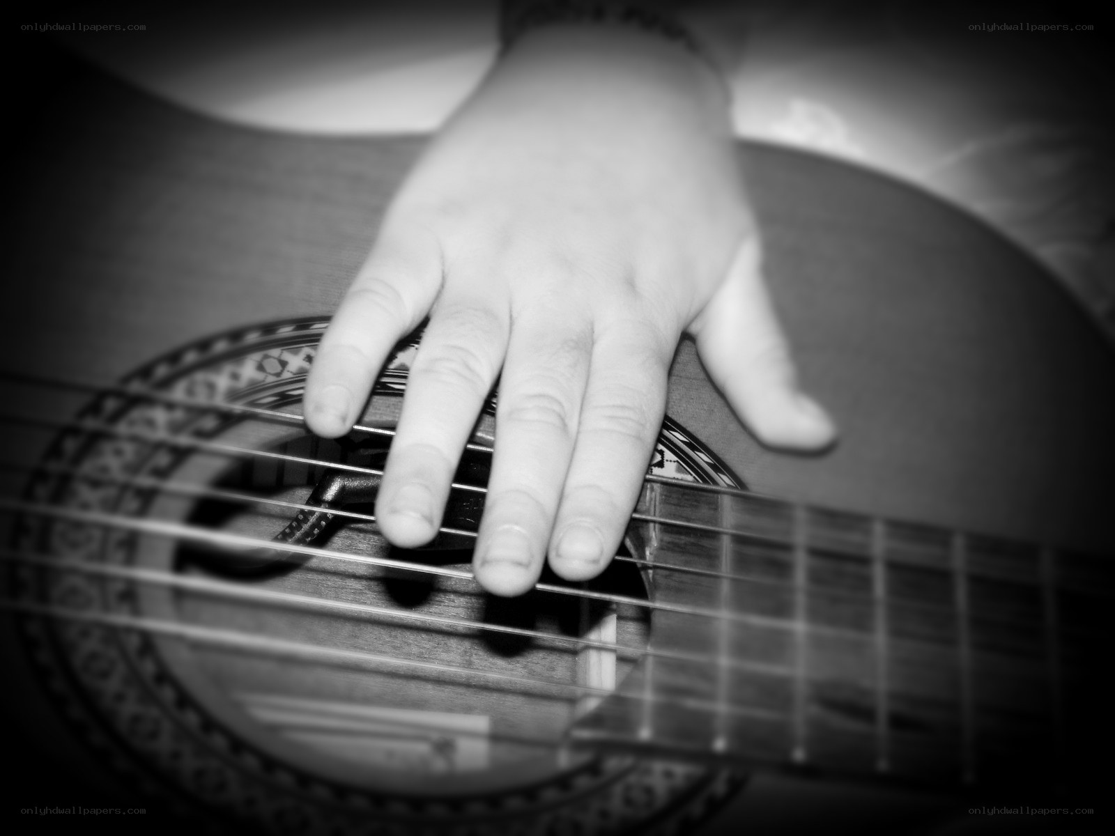 hand on acoustic guitar