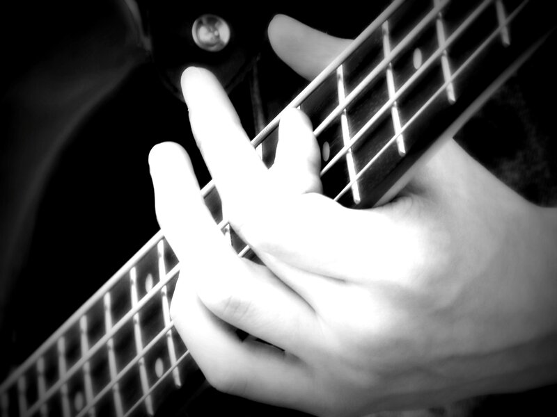 Hand on Bass Guitar — Black