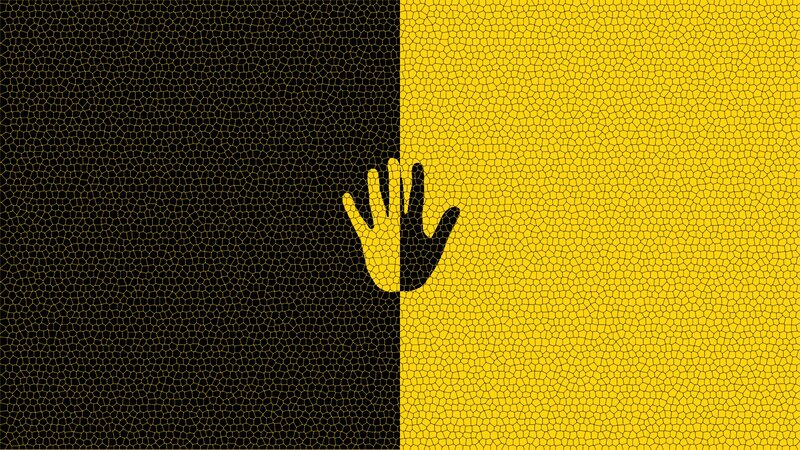 Hand on black and yellow background