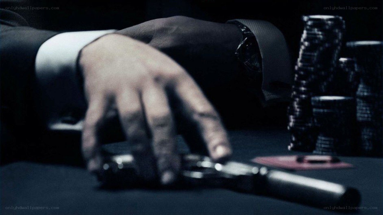Hand on gun at poker table