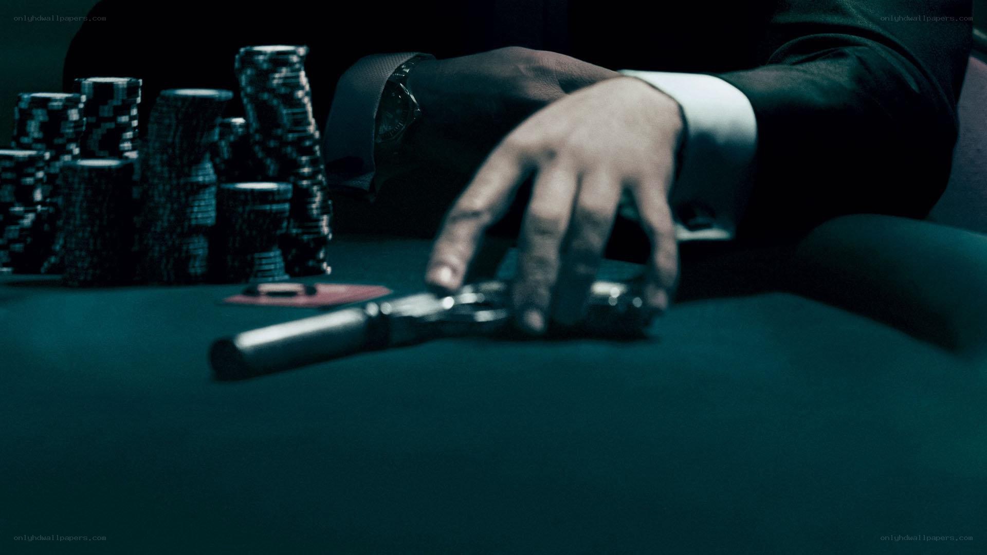 Hand on gun at poker table