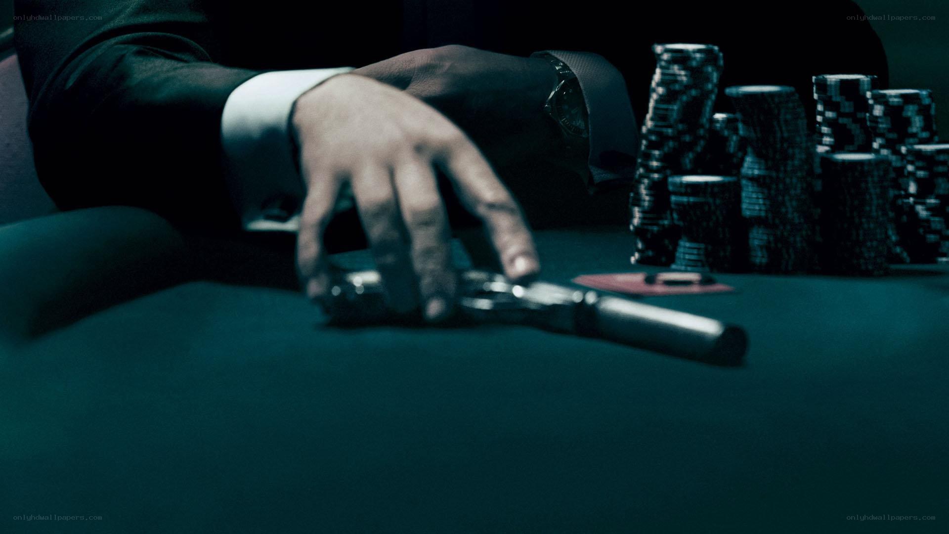 Hand on gun at poker table
