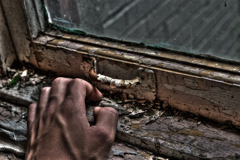 hand on old window frame