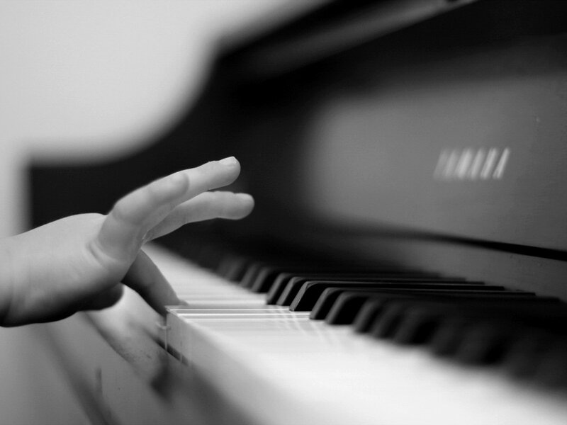 Hand on Piano Keys — Black