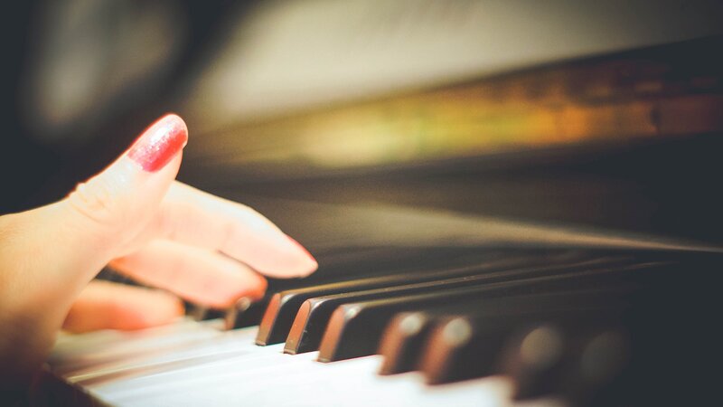 Hand on Piano Keys — White