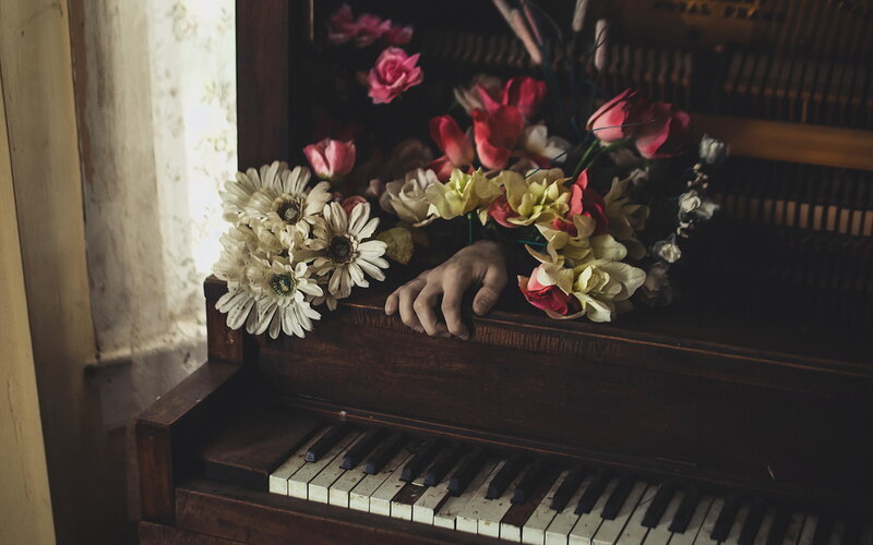 Hand on Piano with Flowers