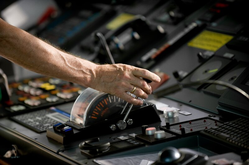 hand on ship control panel