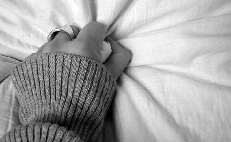 Hand on White Fabric