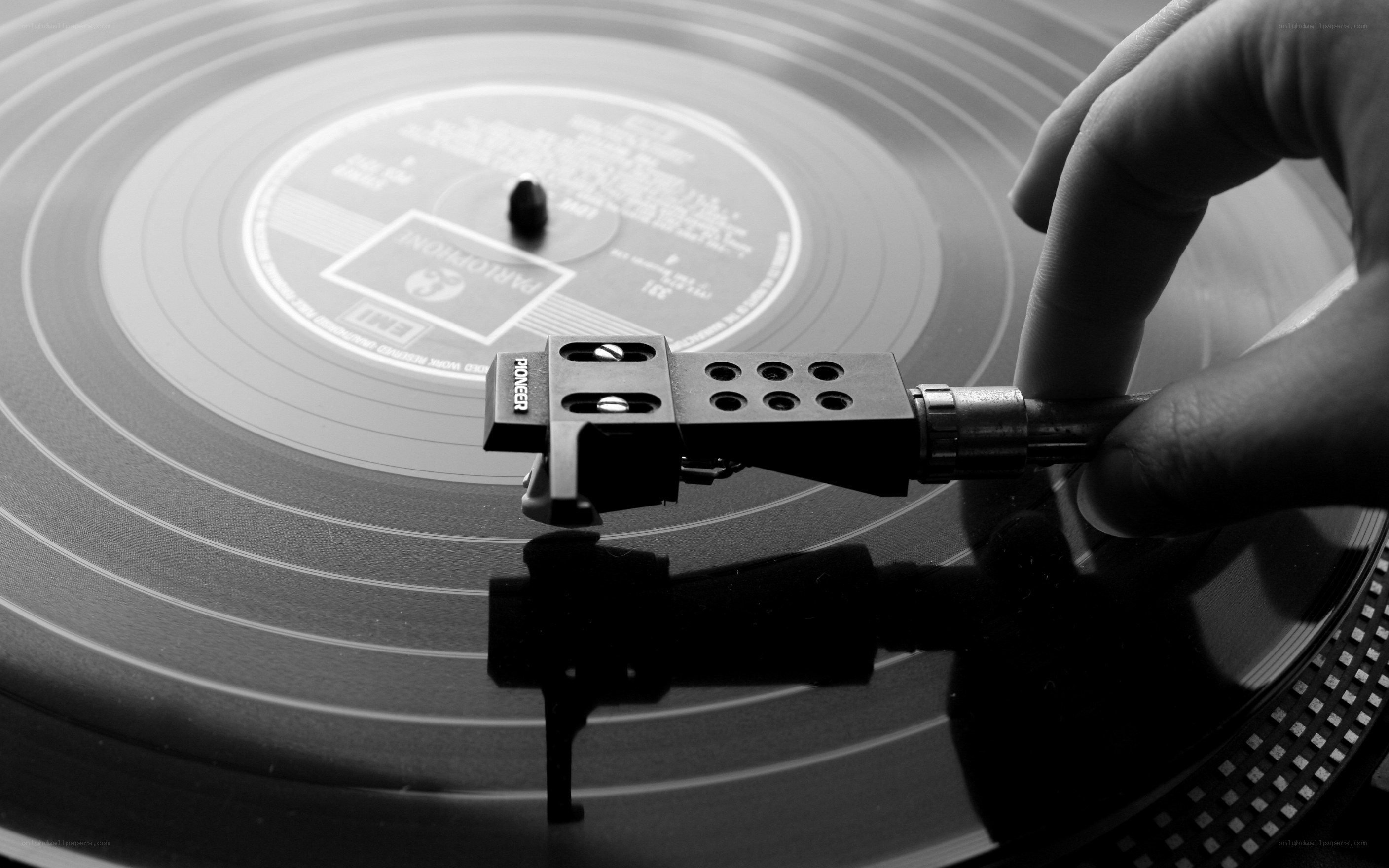 hand placing turntable needle