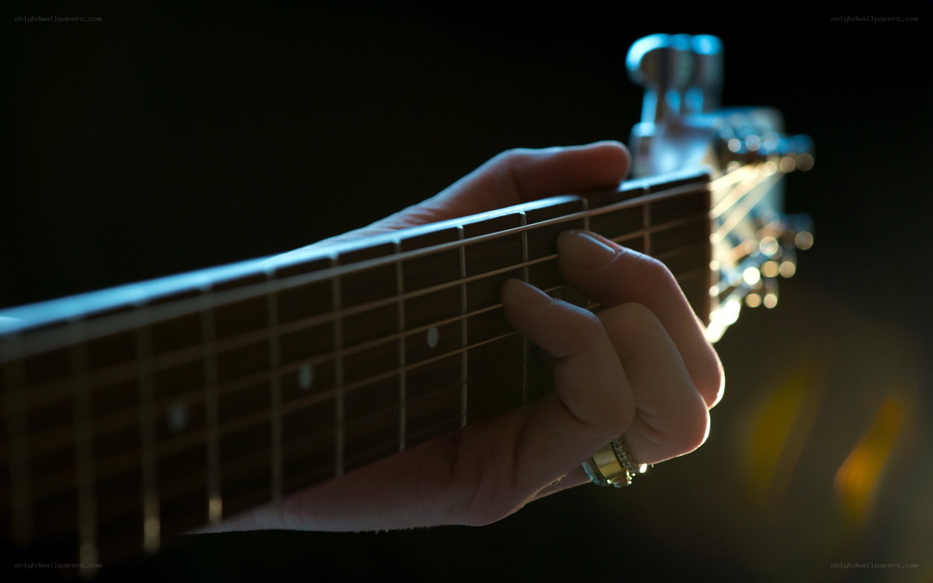 hand playing acoustic guitar