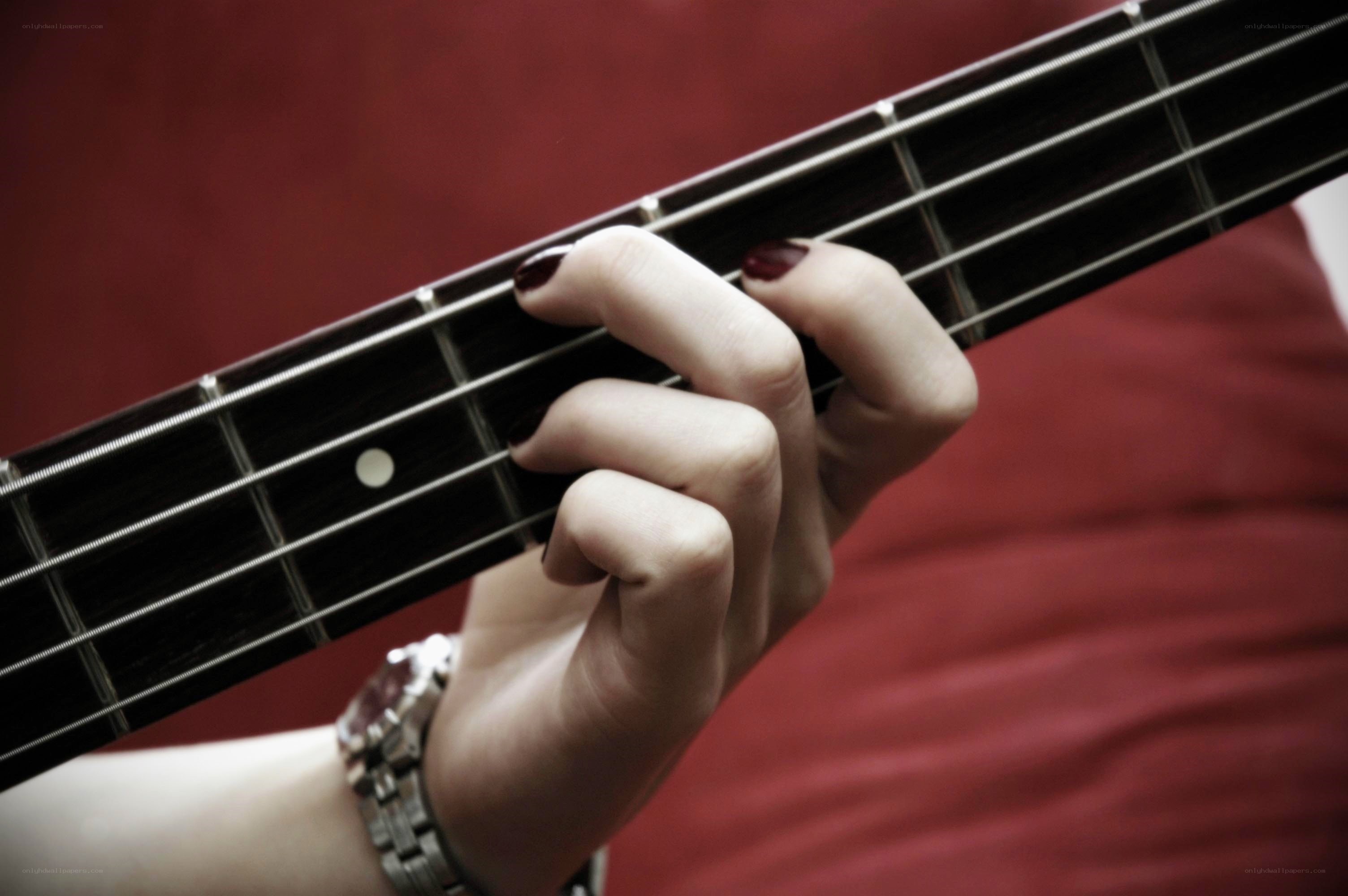 hand playing bass guitar