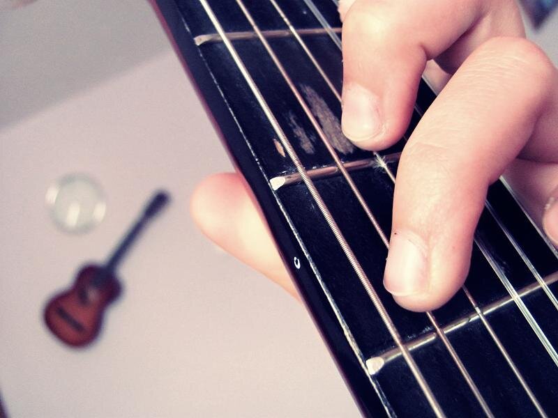 hand playing guitar strings