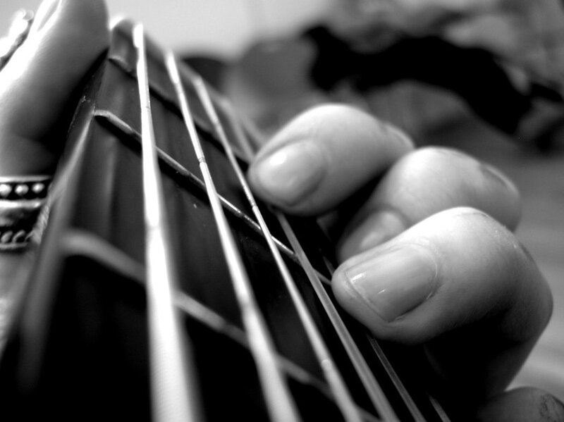 hand playing guitar strings