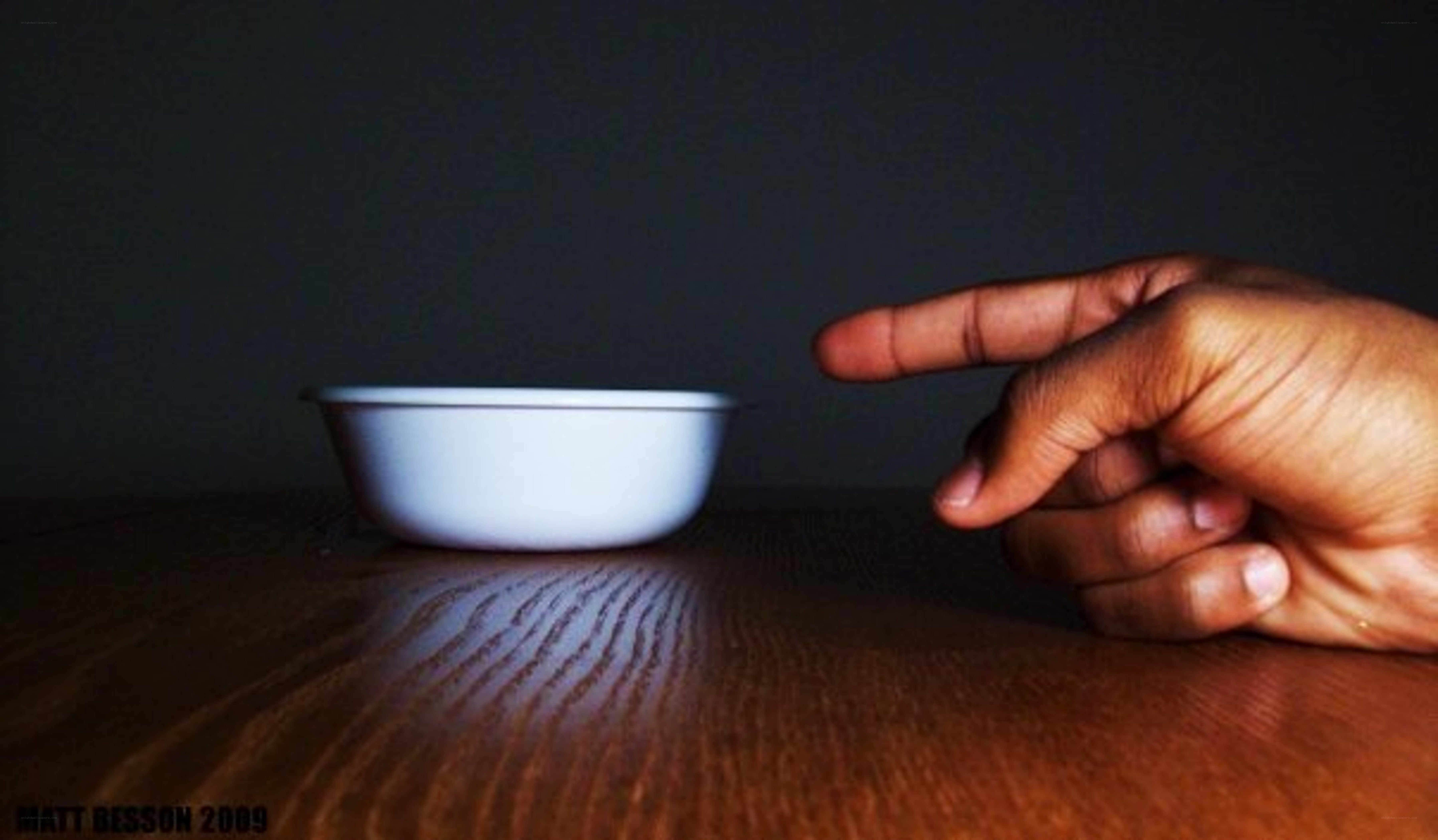 hand pointing at a bowl