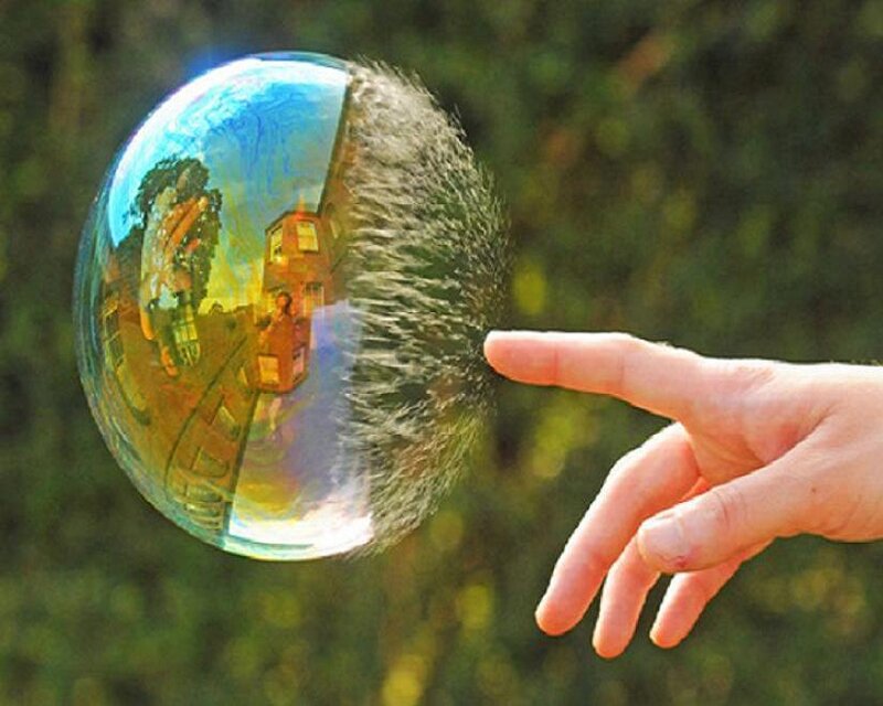 hand popping a bubble