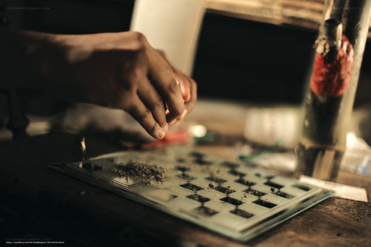 hand preparing substance on chessboard