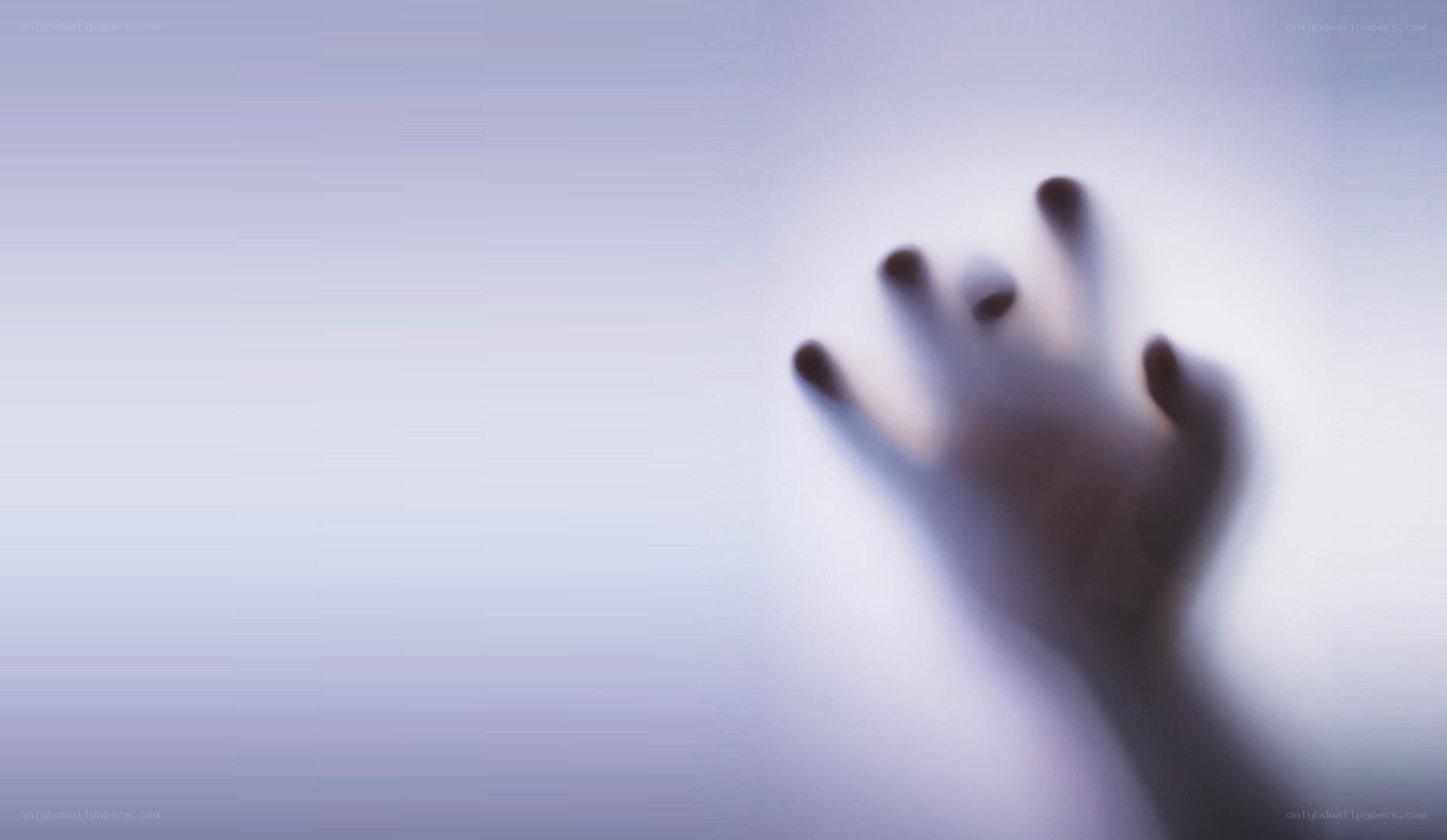 hand pressed against glass