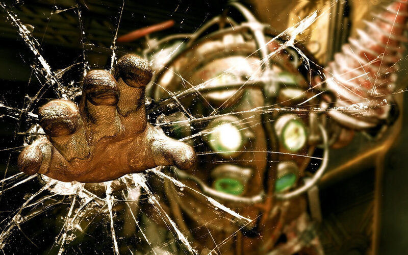 hand pressing against shattered glass