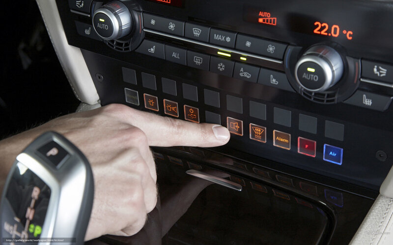 hand pressing car control button
