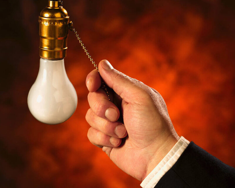 hand pulling light bulb chain