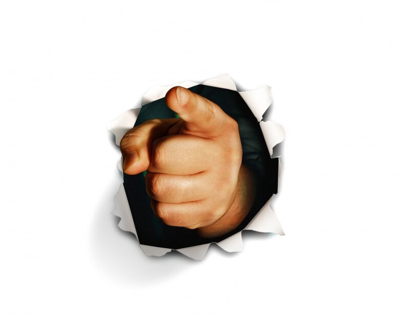 hand punching through paper