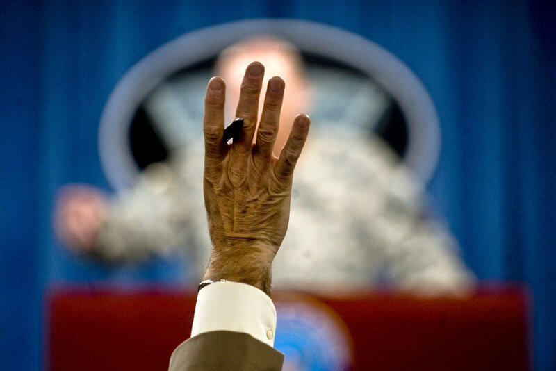 Hand Raised in Front of Speaker