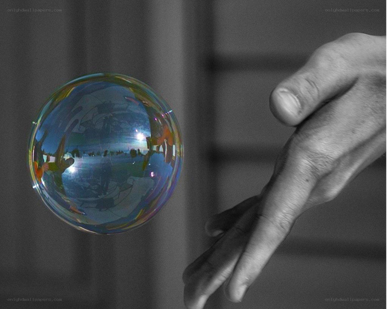 hand reaching for a soap bubble