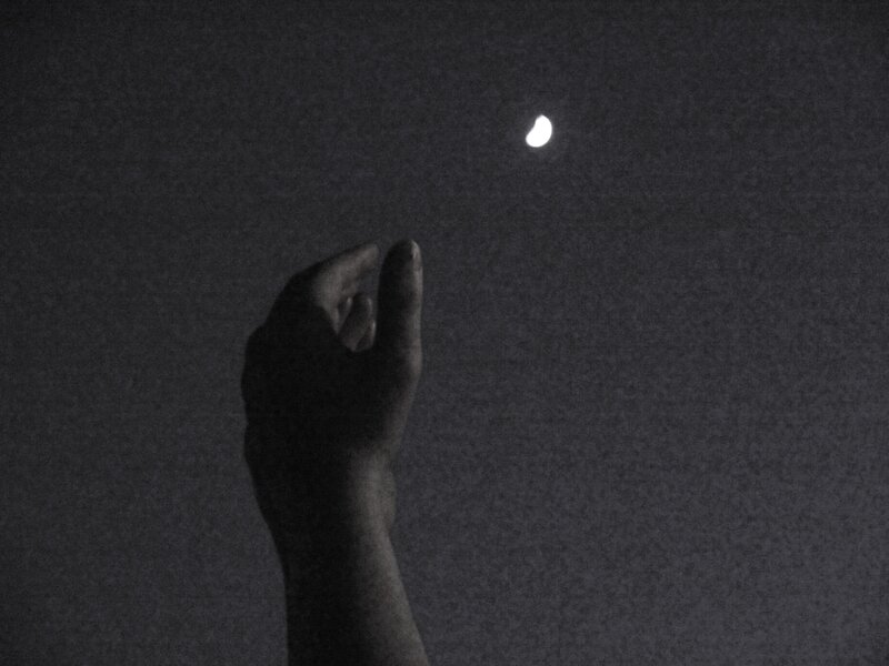 hand reaching for moon