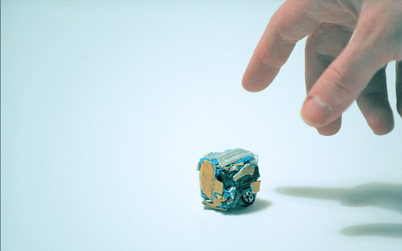 Hand reaching for toy car