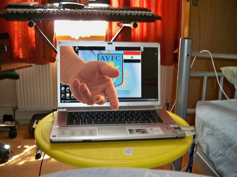 Hand Reaching from Laptop