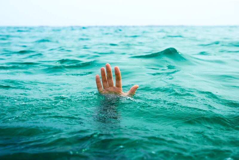 hand reaching from ocean