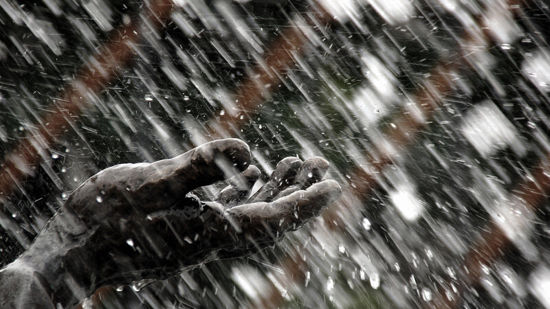 hand reaching in rain
