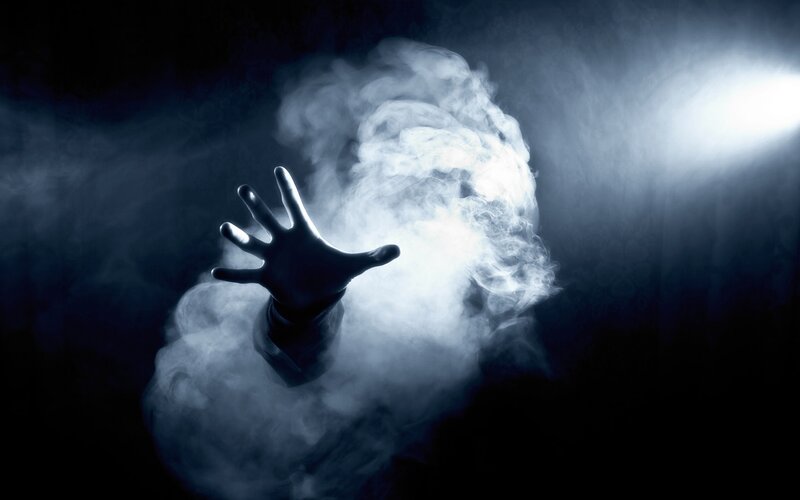 hand reaching through smoke