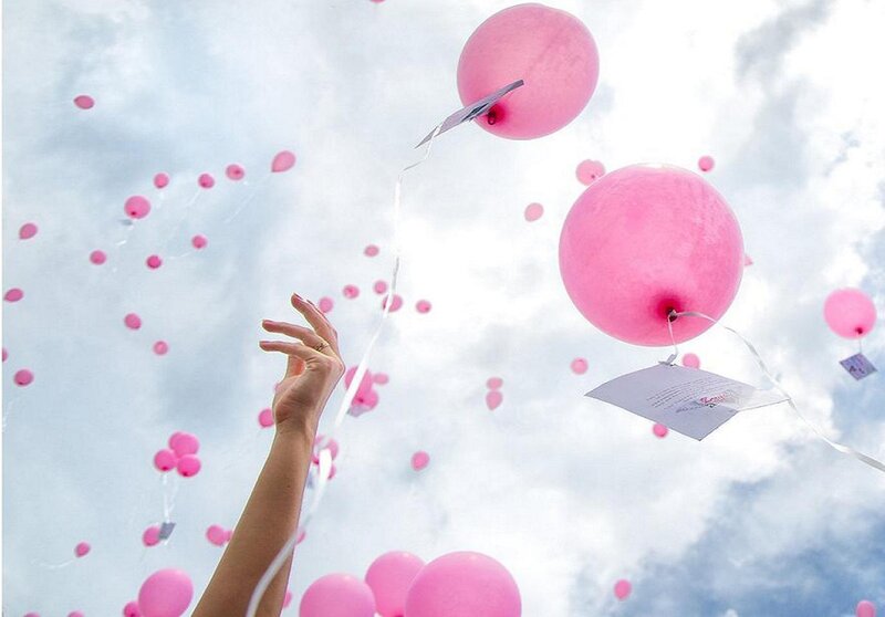 Hand Releasing Pink Balloons