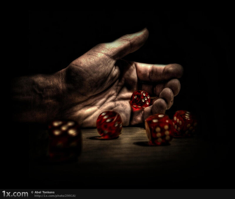 Hand rolling red dice